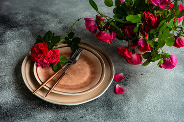 Rustic table setting with red tea roses