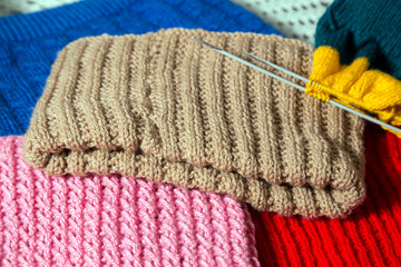 Wool handmade clothing with sewing needles.