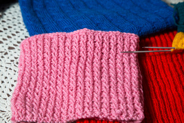 Wool handmade clothing with sewing needles.