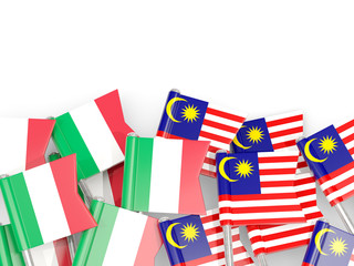 Pins with flags of Italy and malaysia isolated on white.