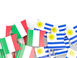 Pins with flags of Italy and uruguay isolated on white.