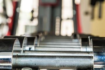 Naklejka premium Iron dumbbell on shelf in fitness gym