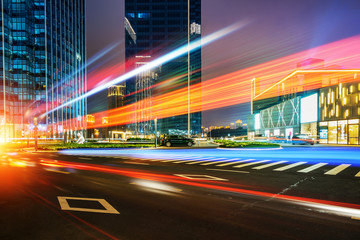 Fototapeta na wymiar abstract image of blur motion of cars on the city road at night，Modern urban architecture