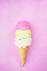 Ice-cream scoops variety in waffle cone on bright pink background. Summer, heat, vacation, refreshment, traditional seasonal cold sweets