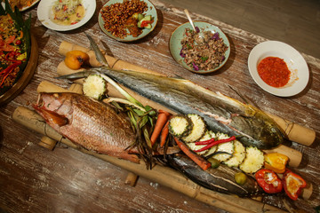Grilled Mahi Mahi, red snapper and tuna fish served on the table, top view