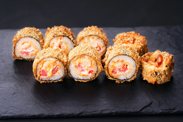 Japanese sushi tempura maki spicy salmon roll on  slate. Japanese traditional fusion food style, restaurant menu