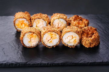 Japanese sushi tempura maki spicy crab roll on  slate. Japanese traditional fusion food style, restaurant menu