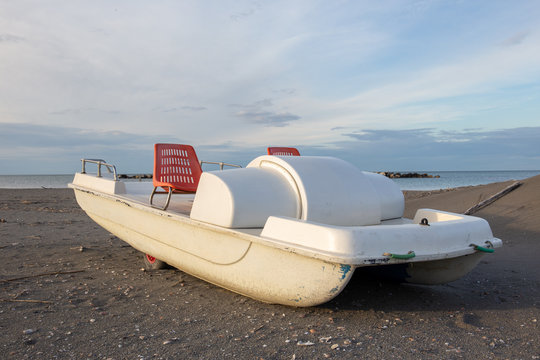 Vintage italian "pedal&ograve;", paddle bpat from the Seventies, abondoned in a Riviera Romagnola beach.