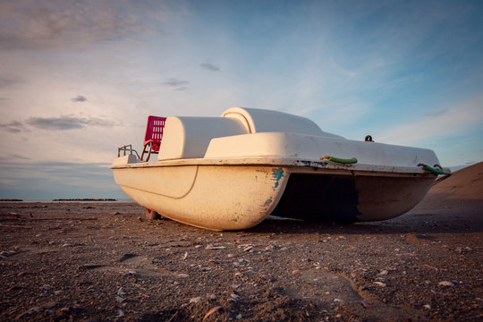 Vintage italian "pedal&ograve;", paddle bpat from the Seventies, abondoned in a Riviera Romagnola beach.