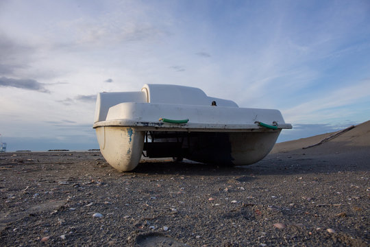 Vintage italian "pedal&ograve;", paddle bpat from the Seventies, abondoned in a Riviera Romagnola beach.