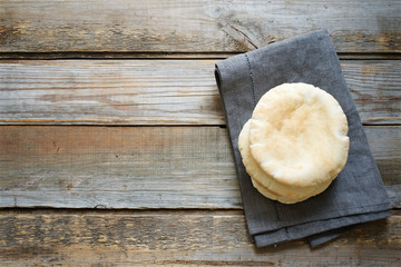 Homemade pita bread. Middle Eastern cuisine. Wooden rustic background