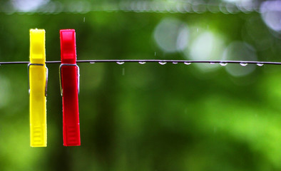 red and yellow pegs in the rain / close up
