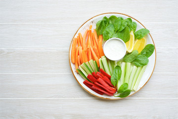 Vegetable dip table. Yogurt garlic sauce and vegetable sticks