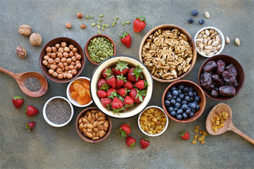 Set of berries, nuts and dry fruits in bowls for a healthy lifestyle. Healthy eating concept
