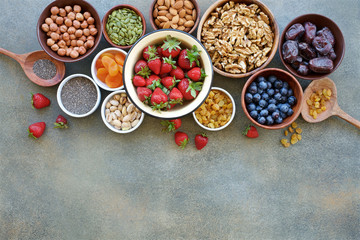 Set of berries, nuts and dry fruits in bowls for a healthy lifestyle. Healthy eating concept