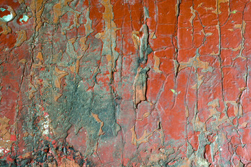 Old cracked red paint, abstract background texture.