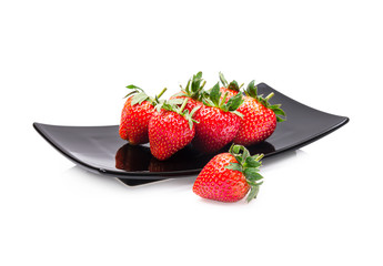 Strawberry on plate on a white background