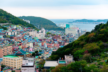 Fototapeta premium Scenic landscape of Gamcheon Culture Village, colorful and artistic tourist attraction with brightly painted houses on hillside of coastal mountain in Saha District, Busan, South Korea