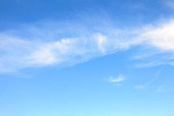the bright blue sky background with some white cloud