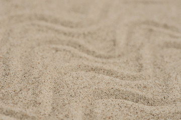 Fototapeta na wymiar wave pattern on sand background selective focus