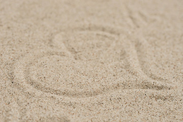 Fototapeta na wymiar heart shape on sand background selective focus