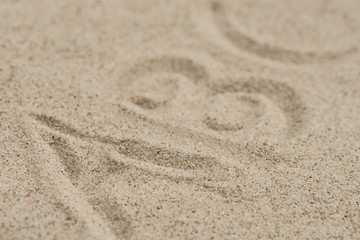 Fototapeta na wymiar abc letters on sand background selective focus