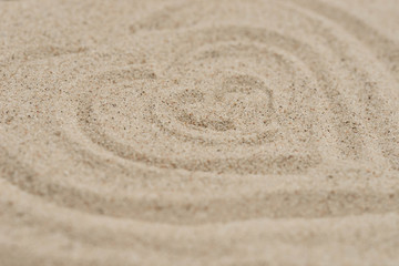 Fototapeta na wymiar hearts shape on sand background selective focus