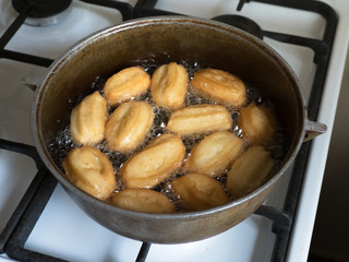 Tulumba are prepared on the stove, fried in oil.