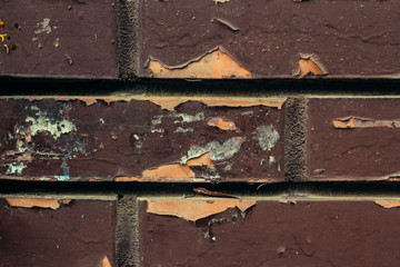 Exfoliation of the marron pain on the brick wall