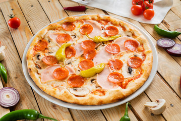 tasty pizza on the wooden background