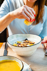 woman eating tuna salad with egg and olives