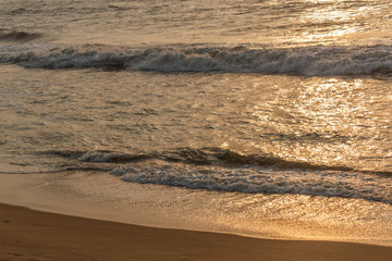 Beautiful golden hour seen at marina beach chennai india, wonderful waves with golden reflection