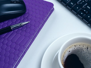 Office table desk. Workspace with note book, keyboard, office supplies and coffee cup on white...