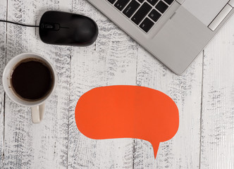 Open metallic laptop speech bubble mouse coffee cup vintage wooden table