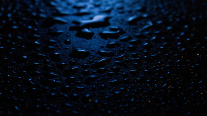 Wet asphalt, night scene of an empty street with a little reflection in the water, the night after the rain. Abstract dark neon background with a wet surface, reflection, neon, glare, blurred bokeh.