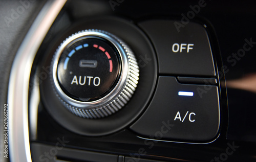 button for activating the air conditioners on the dashboard passenger car