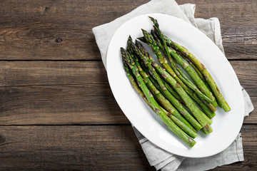 Grilled green asparagus on white plate. top wiew