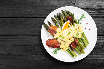 Grilled Asparagus served with poached egg, bacon  and  hollandaise sauce, top view.