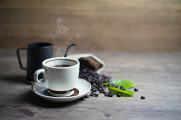 Coffee Time, Fresh black coffee on wooden table, Coffee beans in sacks, cups and kettles, Close-up, Copy-space.