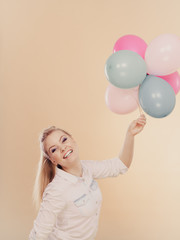 joyful girl playing with colorful balloons