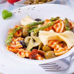 colorful farfalle with green asparagus olives and parma ham
