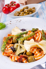 colorful farfalle with green asparagus olives and parma ham