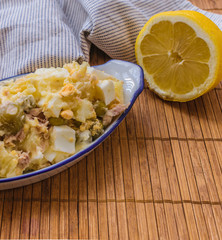 Russian salad on a ceramic plate. Ensaladilla rusa Spanish tapa. Space for copy text