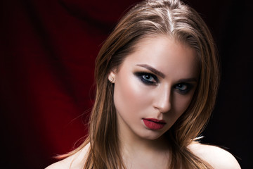 Beauty portrait of a beautiful brunette on black background