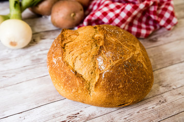 freshly baked bread on wooden kitchen table, top view