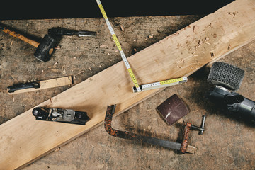 Carpentry equipment tools on work table and wood