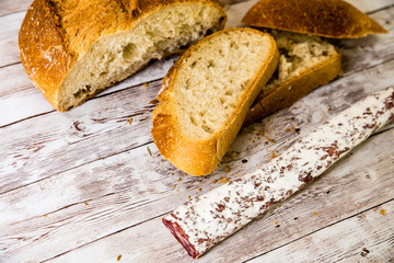 slices of spanish fuet on table with bread