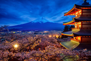 Night sky Mt. Fuji and temple red pagoda in Fujiyoshida with cherry blossom - obrazy, fototapety, plakaty