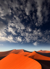 Fototapeta na wymiar Red sand dune with dramatic sky, Sossusvlei, Namibia