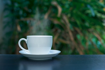 Hot coffee in a white cup on the table